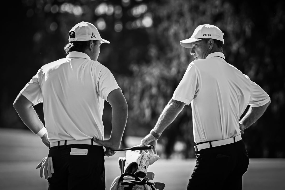 Coach Spar with a player on the course