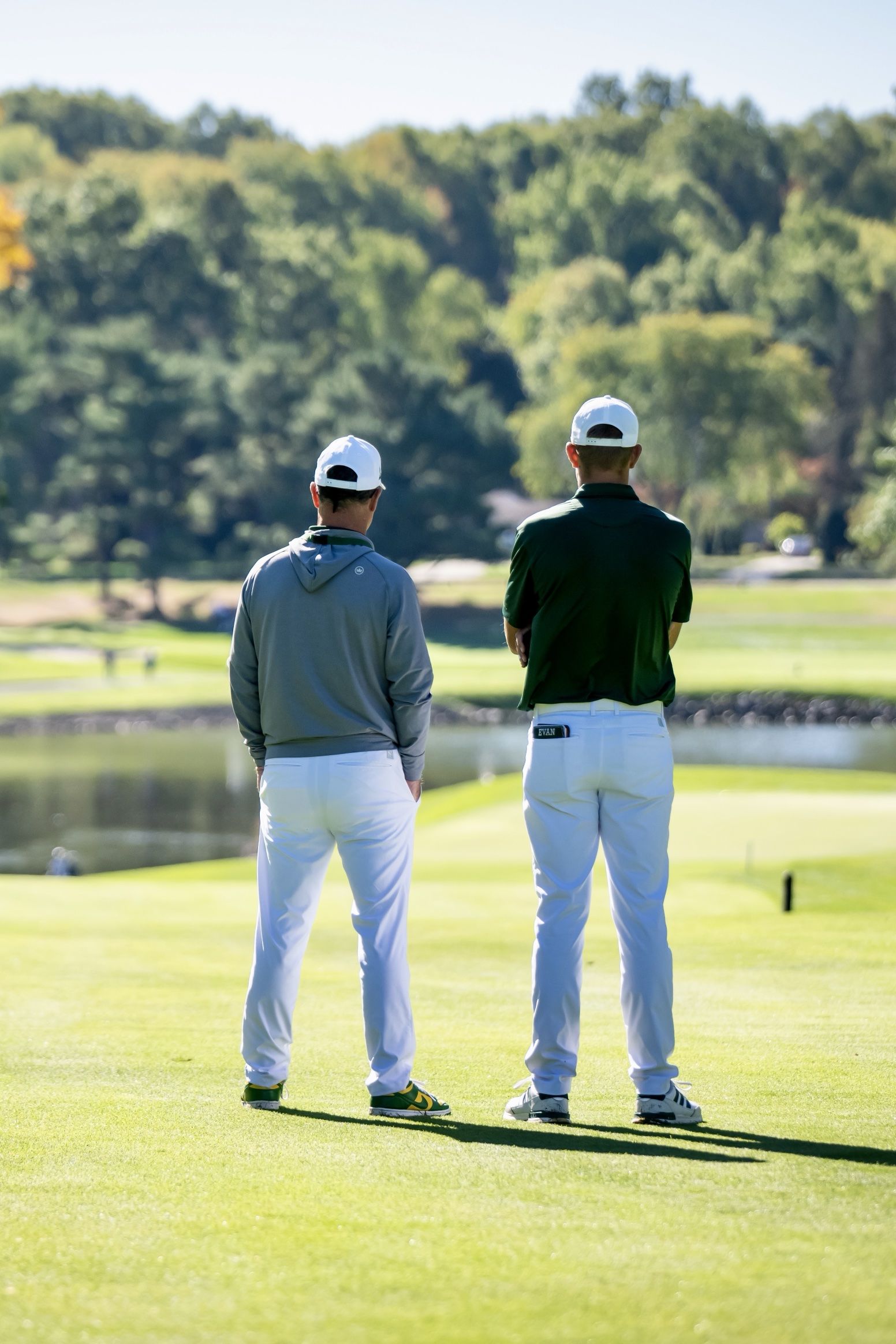 Coach Spar and a player looking down the fairway